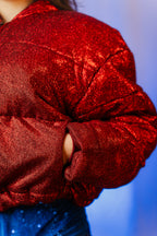 Doudoune - Rouge profond pailletée. Oversize, matelassée et rembourrée. Doublure en satin bleu. THERMO 180. Fermeture zippée et poches latérales zippées. Edition limitée à 3 exemplaires