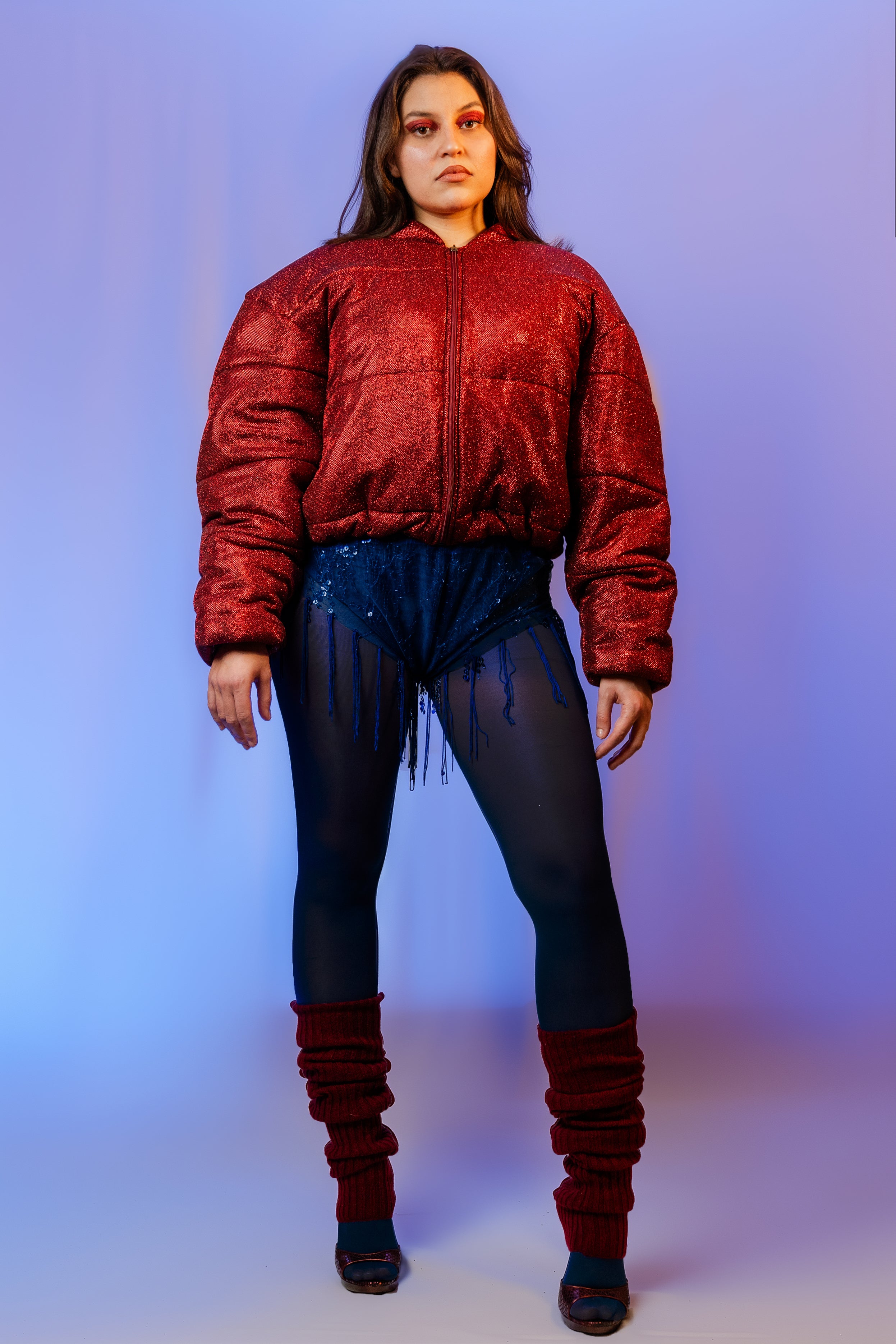 Doudoune - Rouge profond pailletée. Oversize, matelassée et rembourrée. Doublure en satin bleu. THERMO 180. Fermeture zippée et poches latérales zippées. Edition limitée à 3 exemplaires